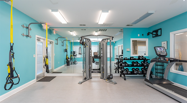 gym in fayetteville apartment complex with TRX and weights
