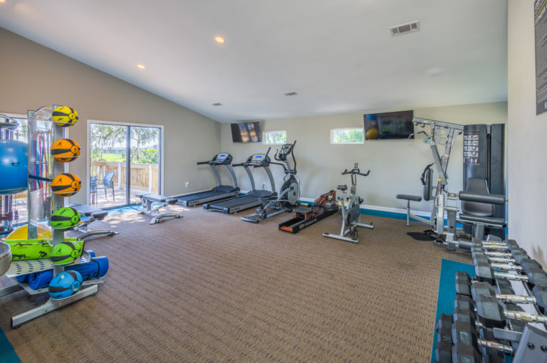 fitness center with free weights and treadmill